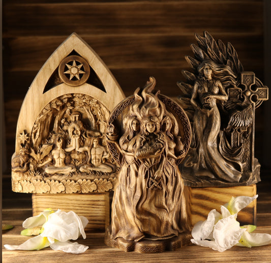 Group shot of masterfully hand-carved Celtic statues including Brigid, and The Morrigan. Showcasing natural ash wood grain and traditional knotwork by ArtCarving Shop.