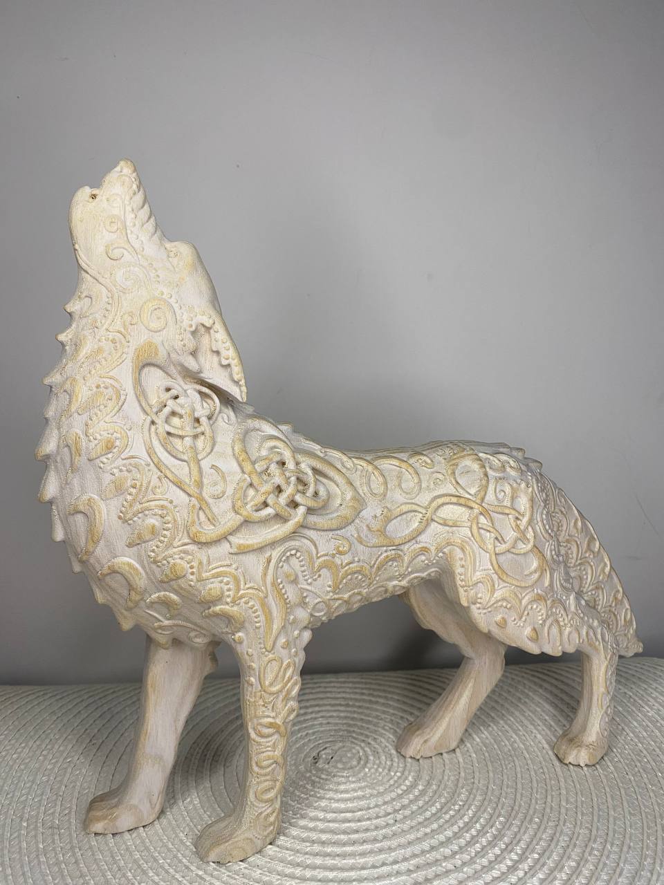 Wooden Fenrir wolf statue with intricate Celtic knot textures displayed as a central focus piece on a Norse pagan Asatru altar.