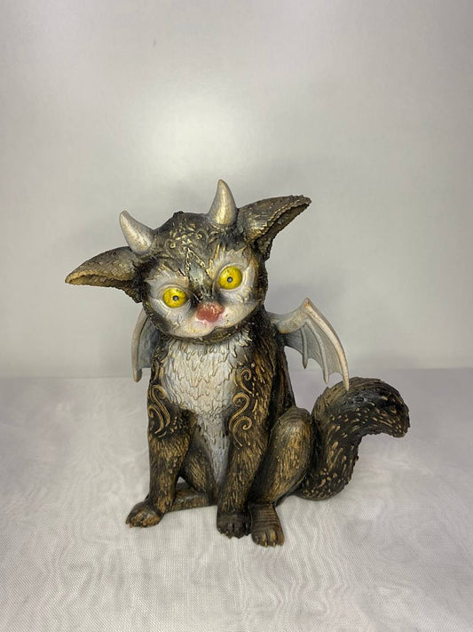 Handcrafted fantasy cat dragon statue featuring bright yellow eyes, small horns, bat-like wings, and an ornate curled tail. This unique mythical creature combines feline charm with dragon-inspired details and intricate decorative carvings, finished in antique wood and bronze tones.
