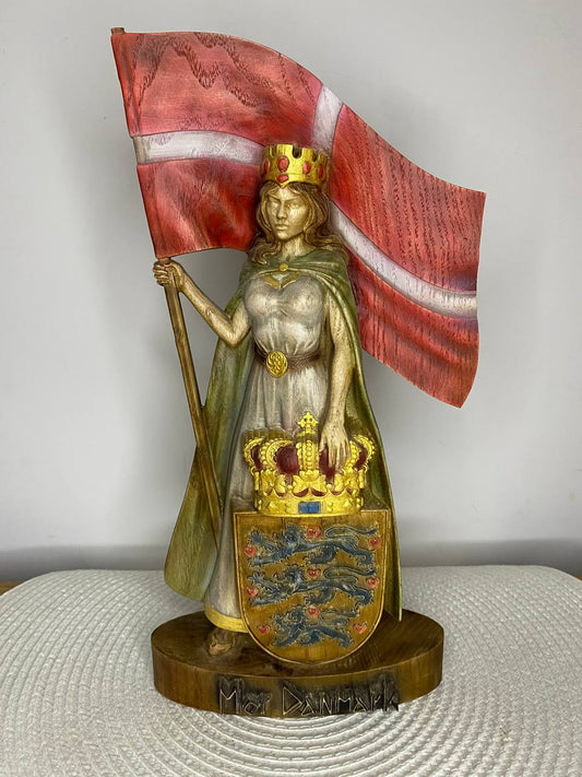 Hand-painted wooden statue of Mor Danmark, crowned female figure holding the Danish flag and royal coat of arms, symbolizing Danish heritage, national pride, and Scandinavian folk art.
