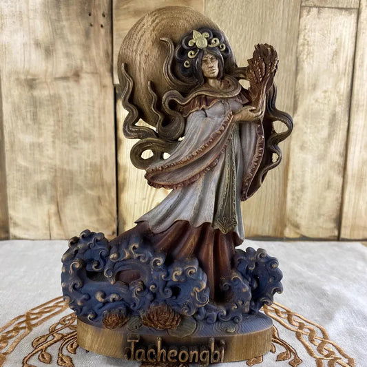 Hand-painted wooden statue of Jacheongbi, Korean goddess of harvest and abundance, holding grain sheaf and standing among waves, inspired by Korean mythology and sacred feminine symbolism.
