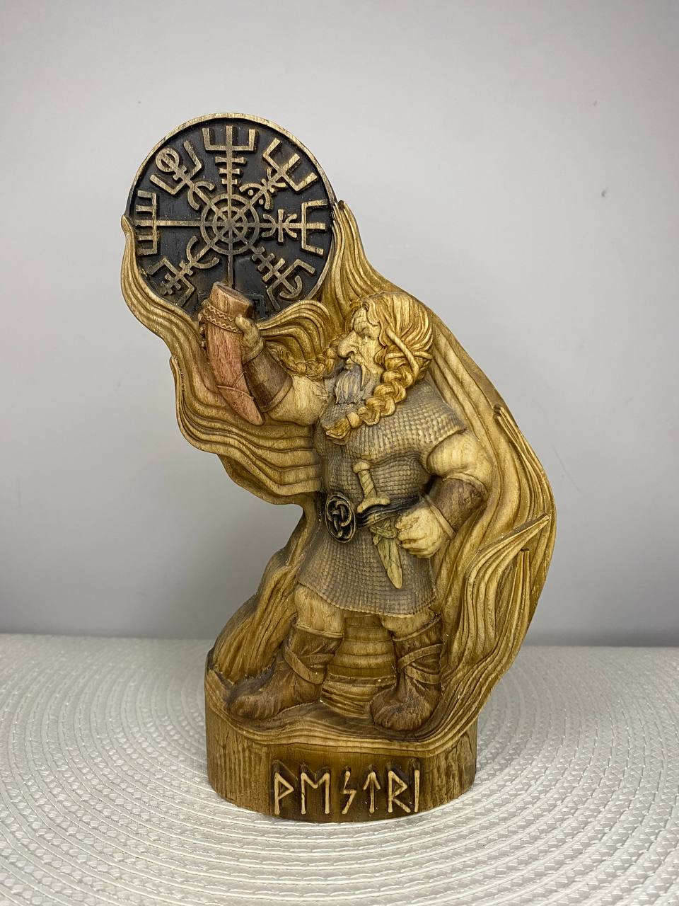 Vestri Norse dwarf figurine, a hand-carved wooden Nordic gnome warrior with braided hair and beard, detailed armor, a sword, and a drinking horn, featuring a large Norse symbol above him and runic carvings on the base.