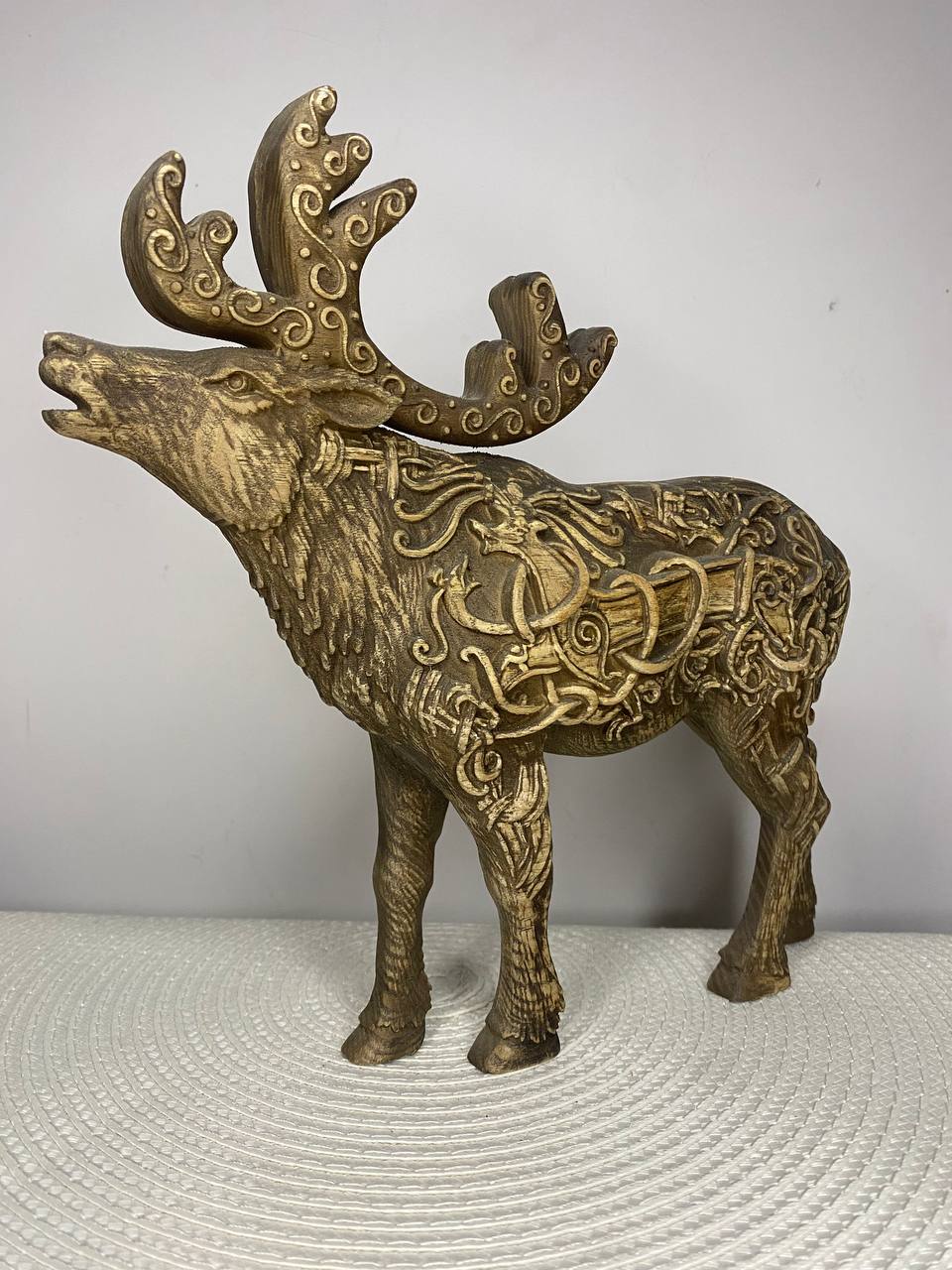 Hand-carved ash wood Celtic moose and caribou statue featuring a majestic antlered animal covered in intricate Celtic knotwork, swirling patterns, and traditional motifs.