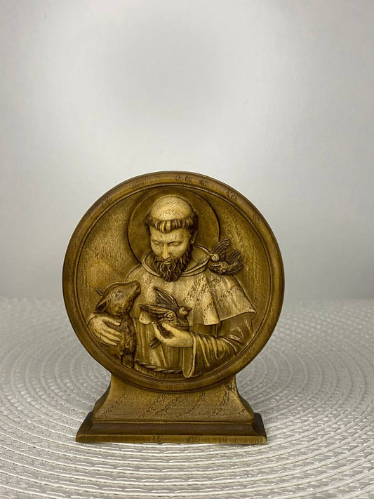 Hand-carved wooden mini statue of Saint Francis of Assisi holding birds and an animal, Catholic religious decor symbolizing compassion, peace, nature, and love for animals.
