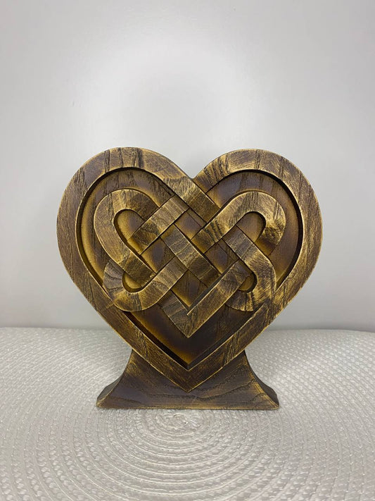 Hand-carved wooden Celtic heart decor featuring an intricate endless knot design, symbolizing eternal love, unity, harmony, and timeless spiritual connection.
