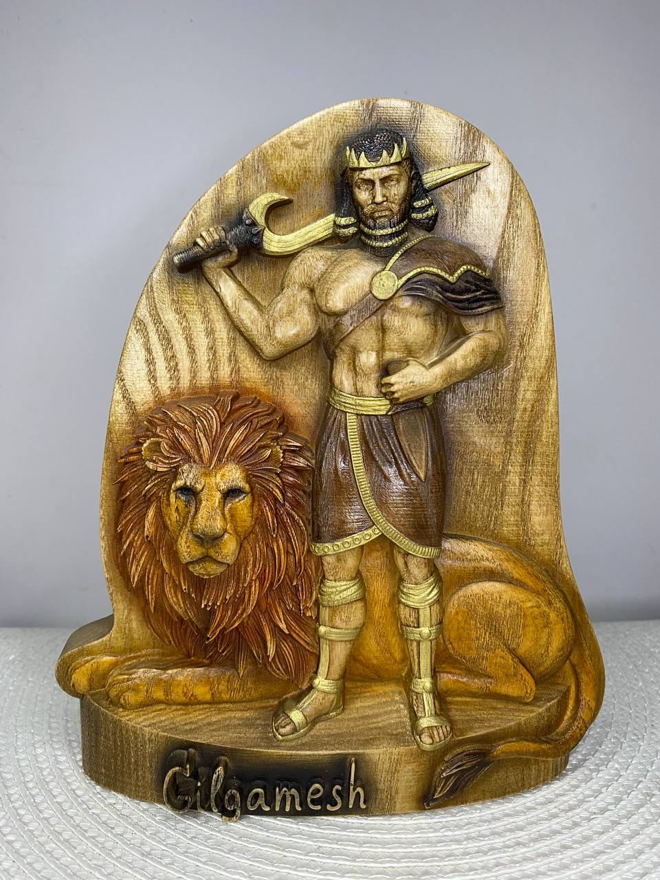 Hand-painted wooden statue of Gilgamesh, legendary king of Uruk and hero of Mesopotamian mythology, standing with a sword beside a majestic lion. The sculpture symbolizes strength, kingship, courage, wisdom, and the epic journey of one of humanity’s oldest mythological heroes. Perfect for historical decor, mythology collections, and ancient civilization enthusiasts.
