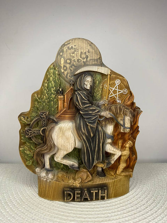 Hand-painted wooden statue of Death riding a white horse beneath a full moon, holding a scythe and surrounded by symbolic elements, inspired by gothic folklore, mortality, transformation, and dark fantasy decor.
