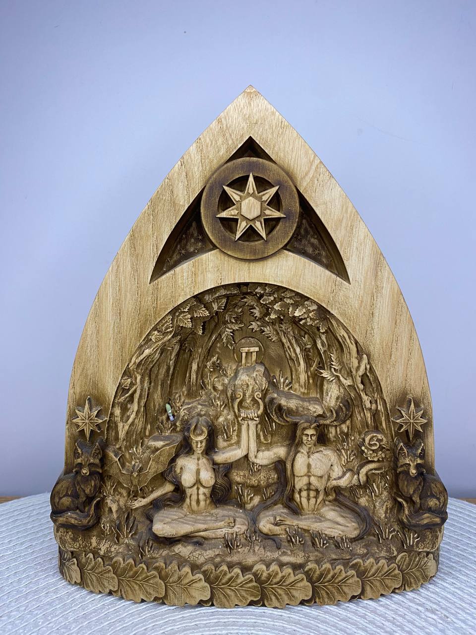 Handcrafted wooden God and Goddess altar inspired by pagan and Wiccan traditions, featuring the Horned God and Triple Moon Goddess seated beneath an ancient forest with sacred animals, oak leaves, and an eight-pointed star, intricately carved from natural wood. Spiritual altar decor for rituals, meditation, and nature-inspired home décor.