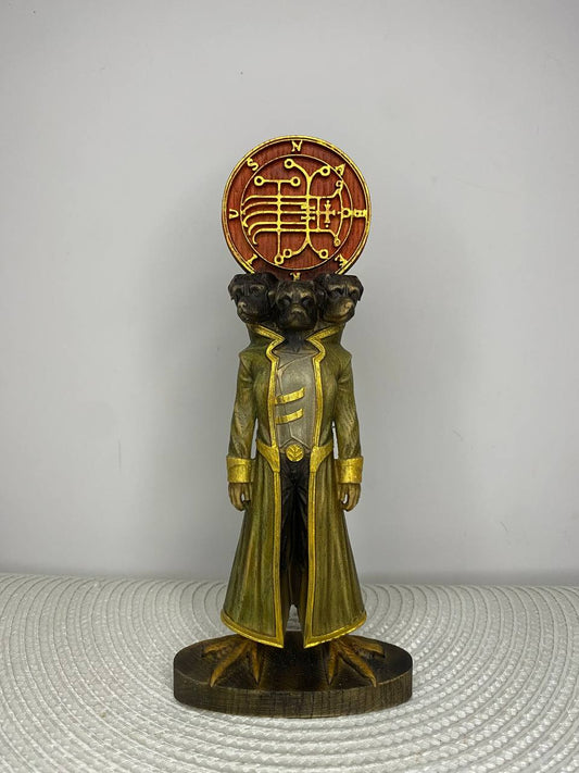 Handcrafted wooden Naberius statue inspired by the Ars Goetia demon, featuring a three-headed black raven in a long ceremonial robe with a glowing sigil above, hand-painted in gold, bronze, and natural wood tones. Occult altar decor and demonology collectible.