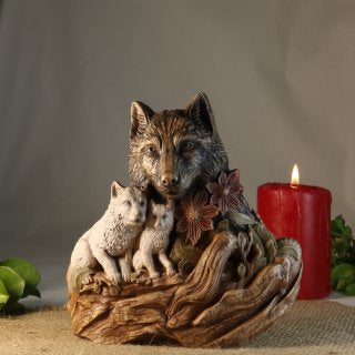 Hand-painted wooden wolf mother statue with two cubs resting on a tree root base, symbolizing family, maternal protection, loyalty, woodland nature, and rustic animal home decor.
